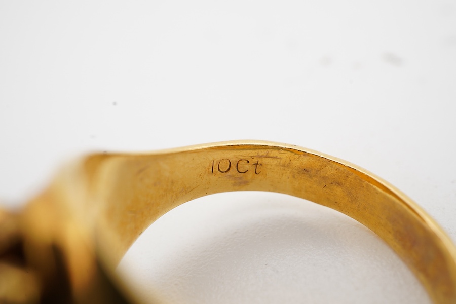 A gold signet ring, of textured design, to a tapering polished band, size N, stamped 10K, gross weight approximately 8 grams